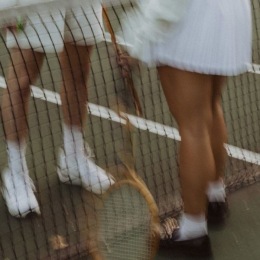 two people on a tennis court