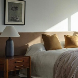 a bedroom with a bed and a side table