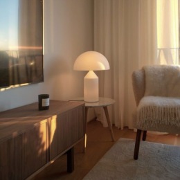 a cradenza a chair and a lamp in a room